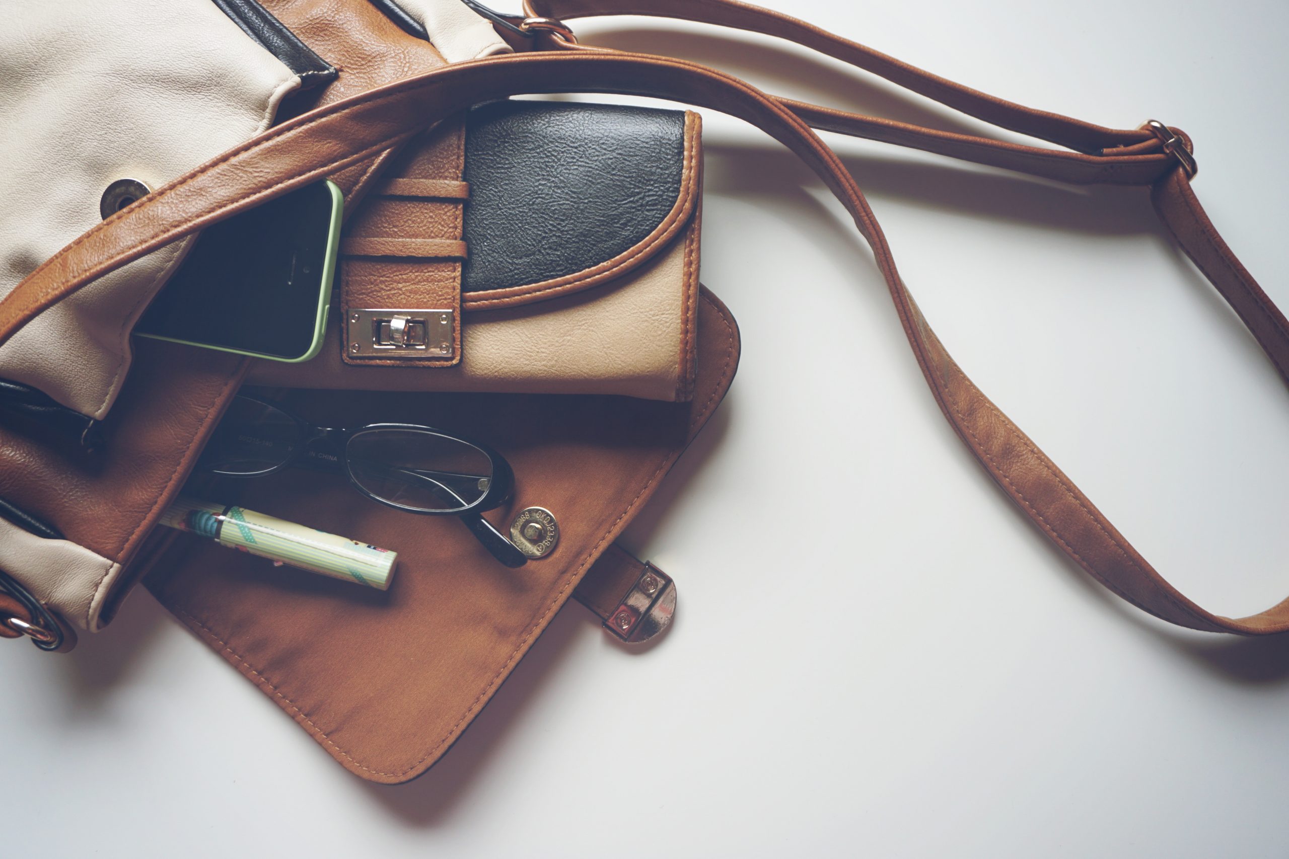 leather material, leather cross body bag, brown leather items, brown leather bag, brown leather bag with glasses